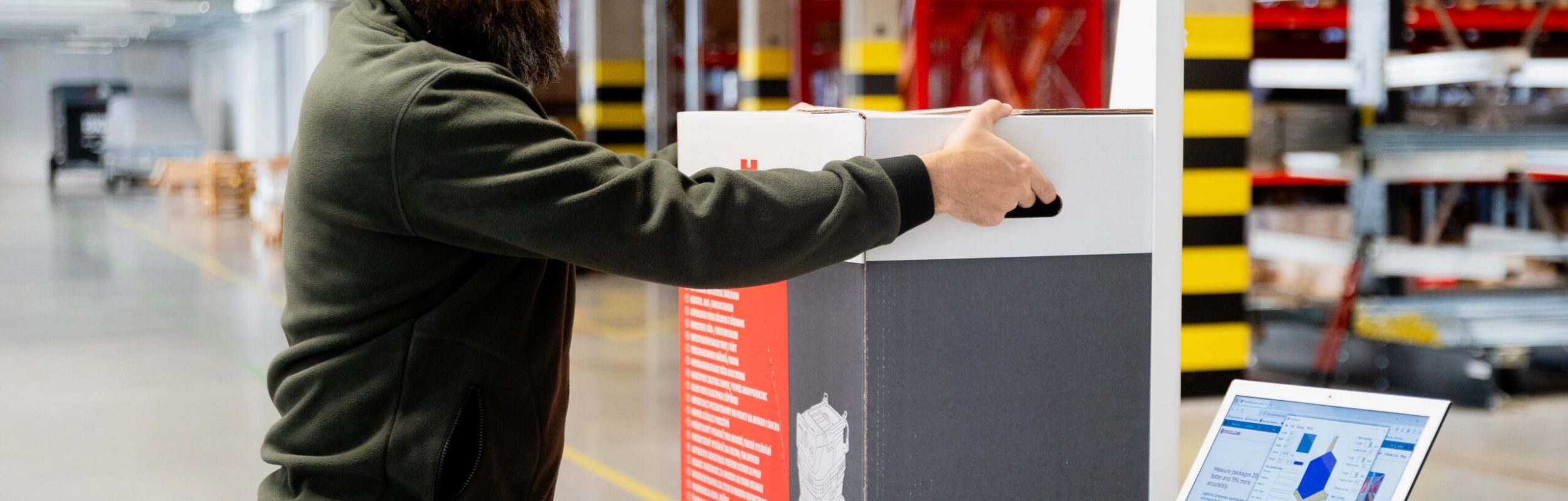 Parcelcube 900 in use at Würth warehouse, measuring packages, shelves of inventory in the background